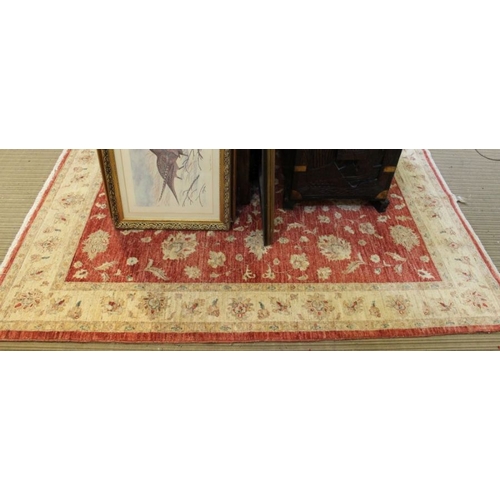 254 - A red ground rug with floral central panel. 230 x 170 cm.