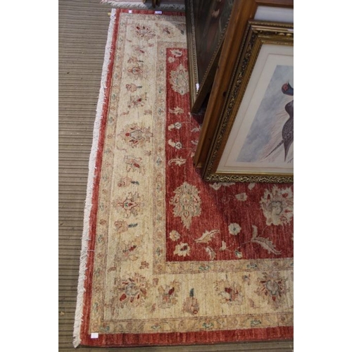 254 - A red ground rug with floral central panel. 230 x 170 cm.