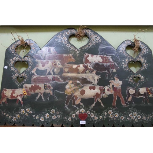 291 - An alpine decorative wall hanging, painted with a herd of cattle with herdsmen, with heart cut outs,... 