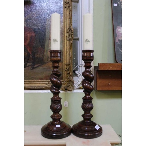 293 - A pair of carved & twisted candle sticks retailed by Mulberry, 46cm high