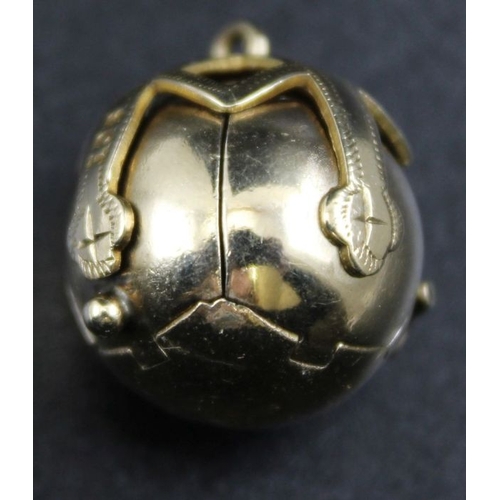 31 - A 9ct gold Masonic orb pendant, opens to reveal six silver gilt pyramids, engraved with symbols, gro... 