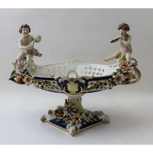 38 - A Continental porcelain bowl, having musician putti at either end, 26cm high