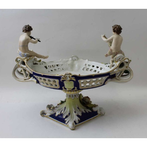 38 - A Continental porcelain bowl, having musician putti at either end, 26cm high