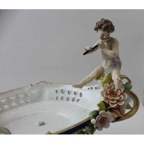 38 - A Continental porcelain bowl, having musician putti at either end, 26cm high