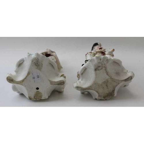 42 - A pair of Derby porcelain figures, a shepherd with his dog & shepherdess with lamb, both playing mus... 