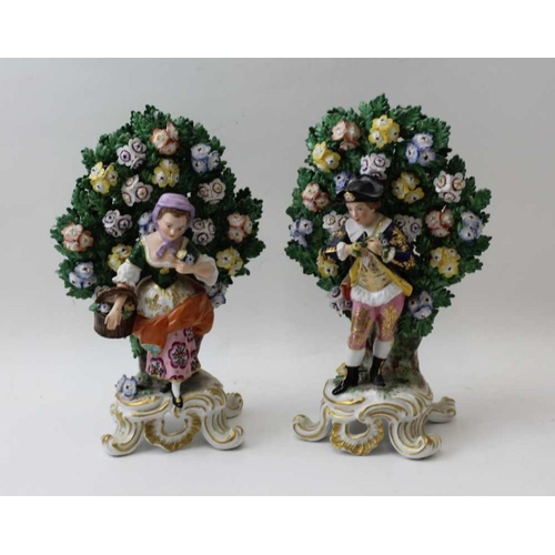 43 - A pair of ceramic bocage backed figures, bearing Derby mark, probably Sampson of Paris, 25cm