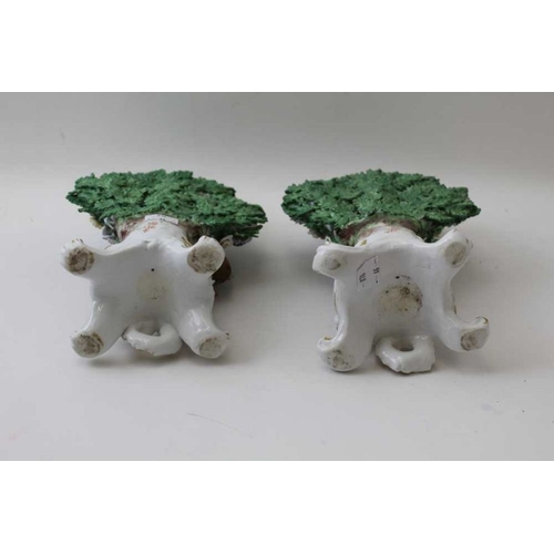 43 - A pair of ceramic bocage backed figures, bearing Derby mark, probably Sampson of Paris, 25cm