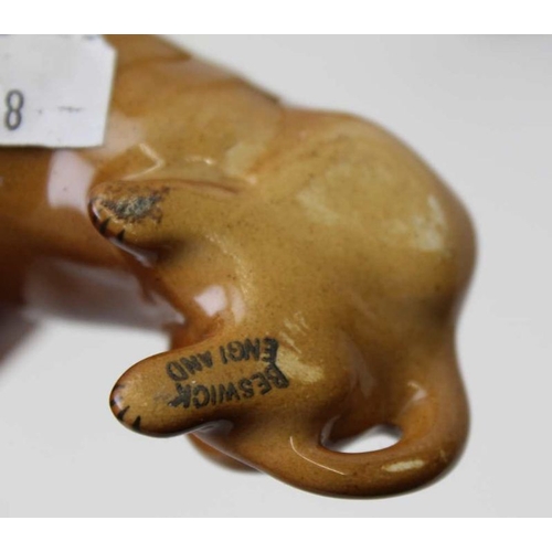 47 - A Victorian Staffordshire pottery cow, 13cm high, together with two Beswick Dachshunds, and a bisque... 