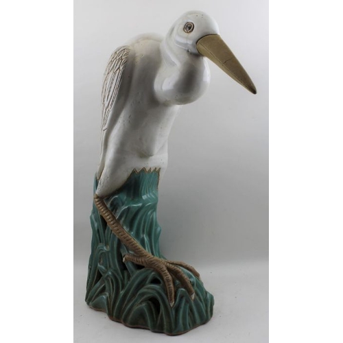 57 - 20th Century probably Japanese pottery model Heron on open work reed base, 62cm high