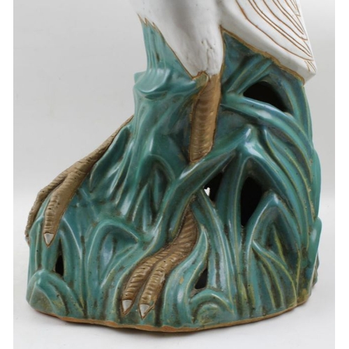 57 - 20th Century probably Japanese pottery model Heron on open work reed base, 62cm high