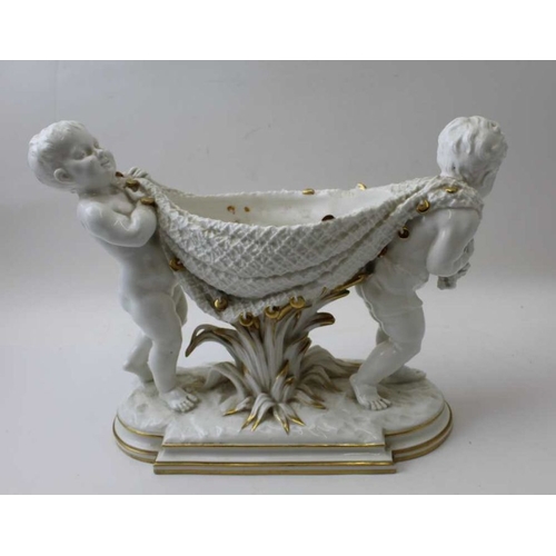 58 - A brownfield ceramic bowl, putti carrying a blanket stretched between them forming the bowl, 25cm hi... 