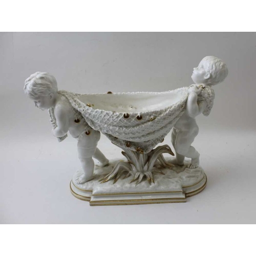 58 - A brownfield ceramic bowl, putti carrying a blanket stretched between them forming the bowl, 25cm hi... 