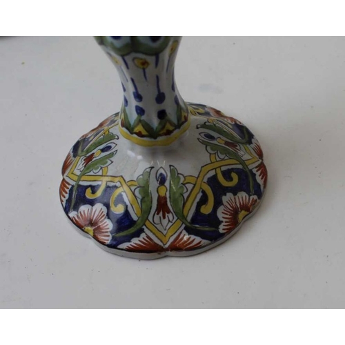 65 - Three various faience candlesticks, decoratively painted, tallest 25cm