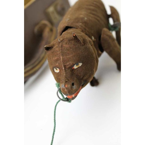 80 - An early 20th century clockwork bear, fabric covered tin plate, 18cm long, together with a painted t... 