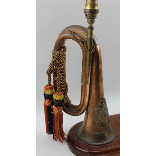 92 - A Royal Marines copper and brass regimental trumpet, bearing crest, wrapped with tassel chords,  mou... 