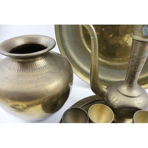 96 - A collection of Middle Eastern brassware, includes a coffee set with pot and cups on tray, together ... 