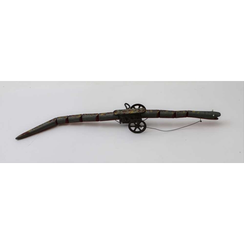 79 - An early 20th century clockwork snake, painted wood body, metal wheels and glass bead eyes, 35cm lon... 