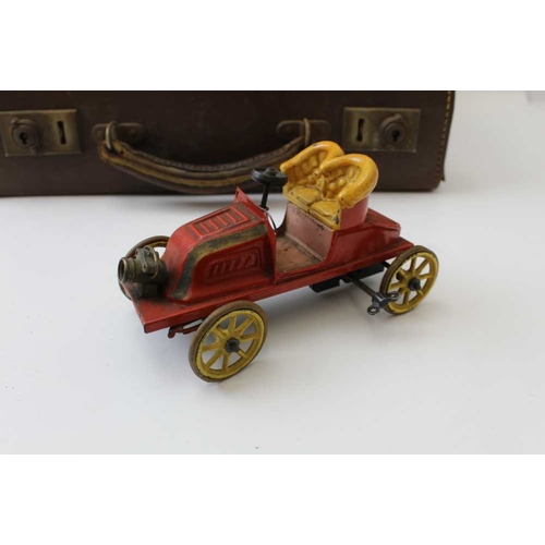 77 - An early 20th century tin plate, clockwork open automobile, red body with yellow set and wheels, 15c... 