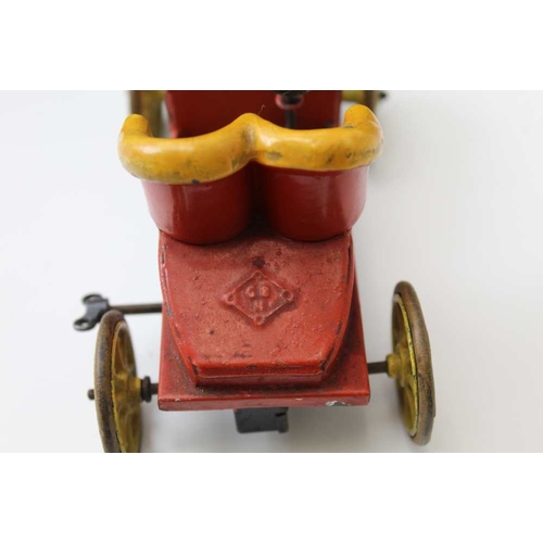 77 - An early 20th century tin plate, clockwork open automobile, red body with yellow set and wheels, 15c... 