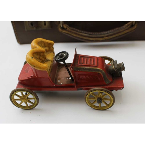 77 - An early 20th century tin plate, clockwork open automobile, red body with yellow set and wheels, 15c... 