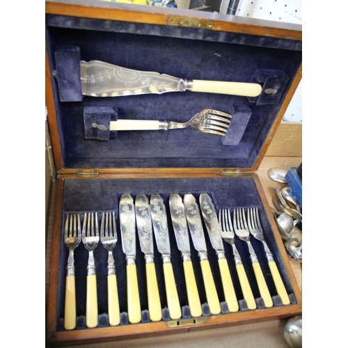 143 - A varied selection of table cutlery and serving utensils, some silver.