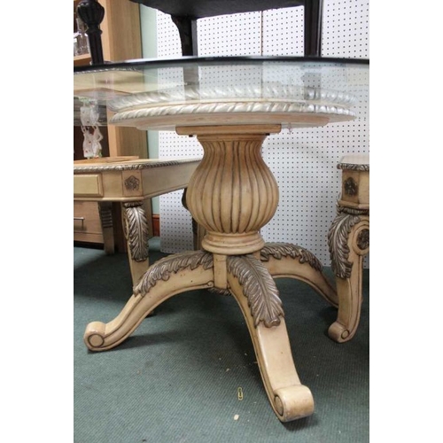 21 - A circular bevel glass topped table, on fancy carved & painted four legged baluster column