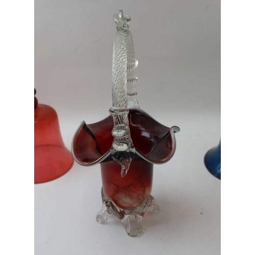 224 - A cranberry glass bell having a green glass handle, 31cm high, together with one other glass bell, a... 