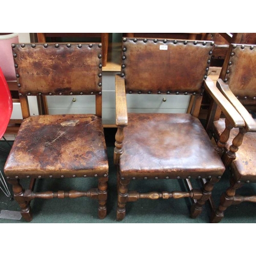 32 - Set of six leather Cromwellian design dining chairs to include two carvers. With Brass stud work.