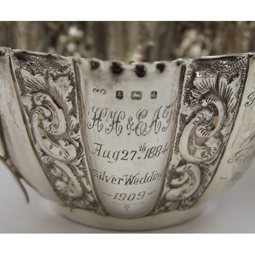 12 - E.J. Houlston, an Edwardian silver milk jug and sugar bowl, embossed floral decoration, Birmingham 1... 