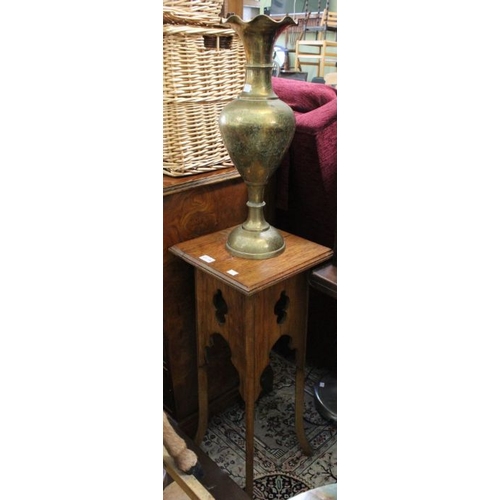 138 - A small carved four legged side table together with a large brass vase