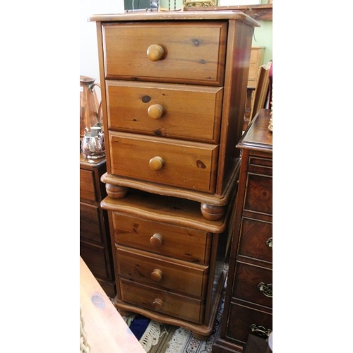 141 - A pair of pine three drawer bedside cabinets