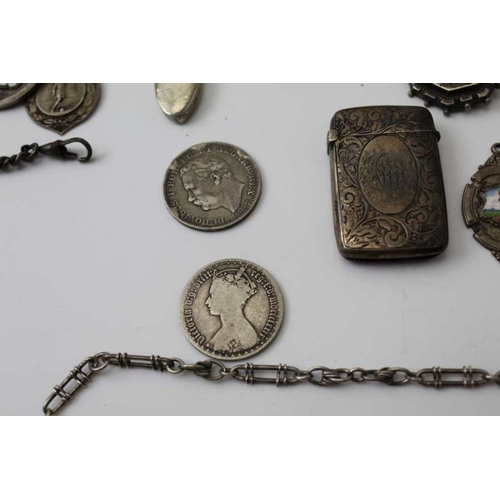 18 - A quantity of silver items, includes sporting fobs, spoons, vesta case, coins, silver mounted cigar ... 