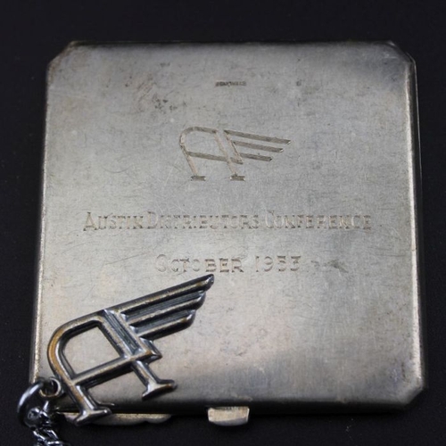 21 - Austin Motors Birmingham a commemorative silver compact 1953, with a key fob and three fancy brooche... 