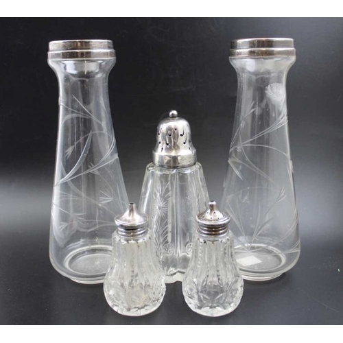 24 - A pair of silver rimmed glass vases, Birmingham 1921, 21cm high, together with a silver topped glass... 