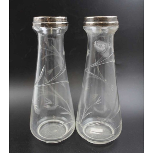 24 - A pair of silver rimmed glass vases, Birmingham 1921, 21cm high, together with a silver topped glass... 