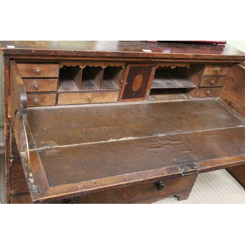 281 - An oak three drawer Secretaire, three drawers beneath a drop front writing desk. 107 x 53 x 105 cm.