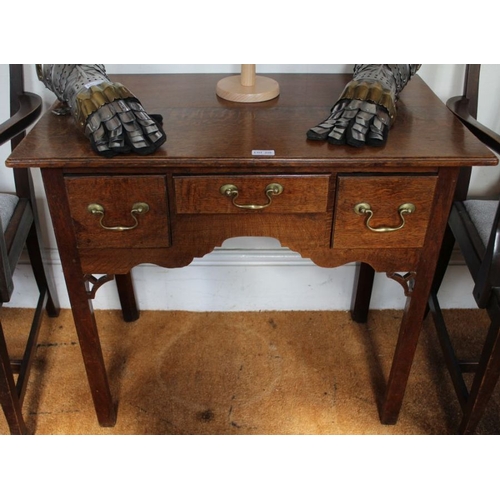 298 - An early 19th century oak lowboy with three drawer front, supported on plain canted legs, 72cm x 85c... 