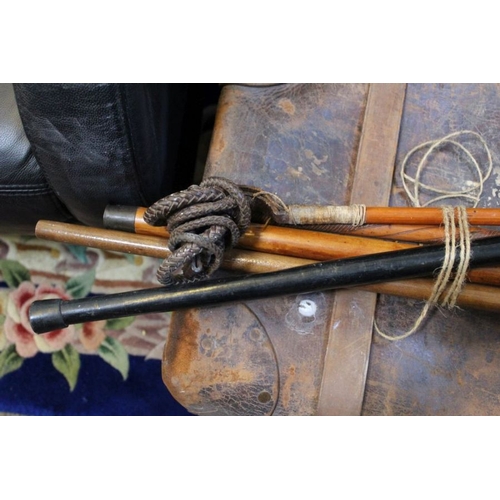 307 - A riding crop, with antler handle, and silver band, together with four walking sticks, one a Malacca... 