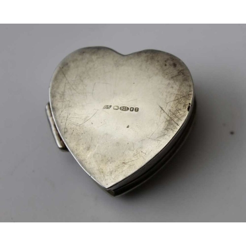 31 - A silver cigarette case, Chester 1899, together with a silver matchbox, and a silver heart shaped pi... 