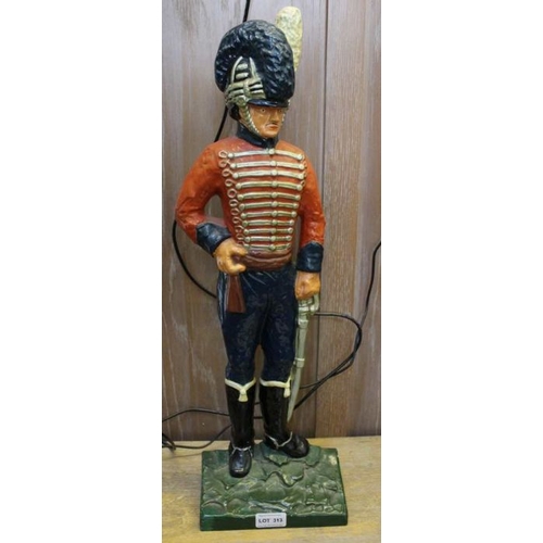 313 - Baltique - Stratford upon Avon, a cast and painted doorstop in the form of a guard 61cms tall, purch... 