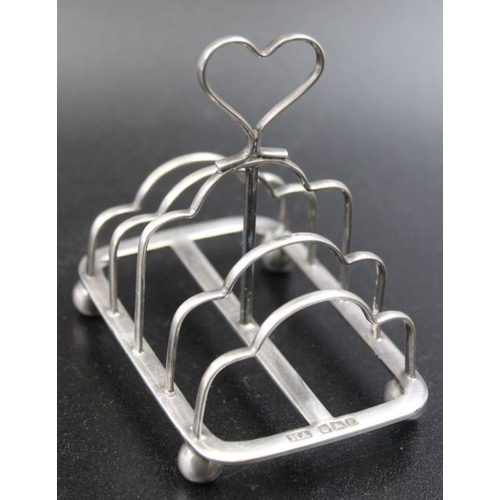 4 - A Victorian silver toast rack, with heart handle, raised on ball feet, Sheffield 1899, 55g