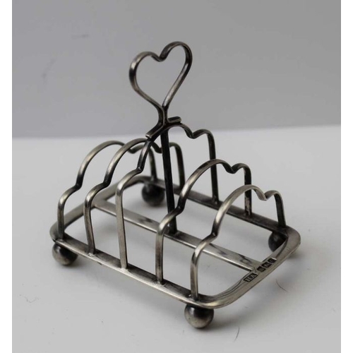 4 - A Victorian silver toast rack, with heart handle, raised on ball feet, Sheffield 1899, 55g