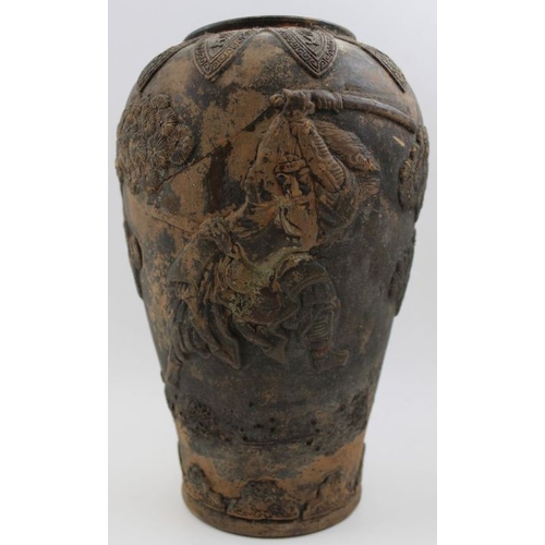 73 - A Japanese earthenware vase moulded with Samurai in a landscape, in the round  c.1900, incised marks... 