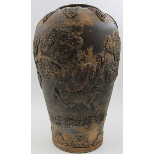 73 - A Japanese earthenware vase moulded with Samurai in a landscape, in the round  c.1900, incised marks... 