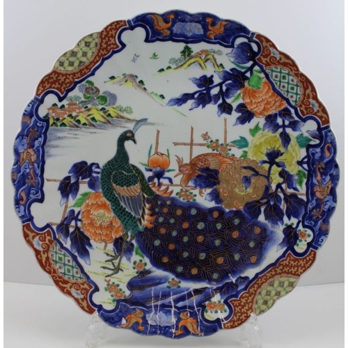 75 - A large Japanese porcelain charger, painted in the Imari taste, all over design of Peacocks in a Peo... 