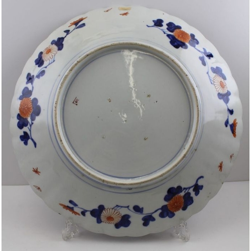 75 - A large Japanese porcelain charger, painted in the Imari taste, all over design of Peacocks in a Peo... 