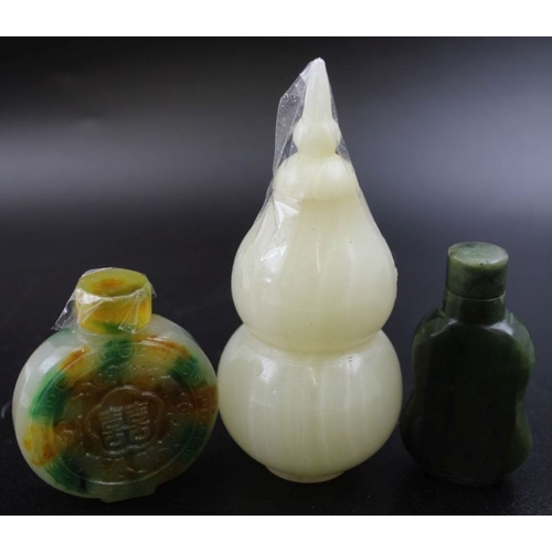 93 - Three Archaic design Chinese snuff bottles, carved from various green stones, including mutton fat t... 