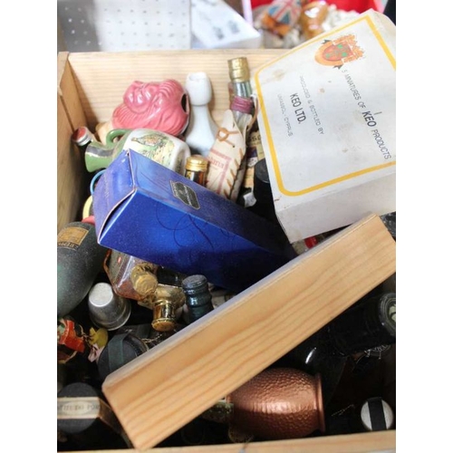 219 - A wooden box of approx 50 miniature wines & spirits