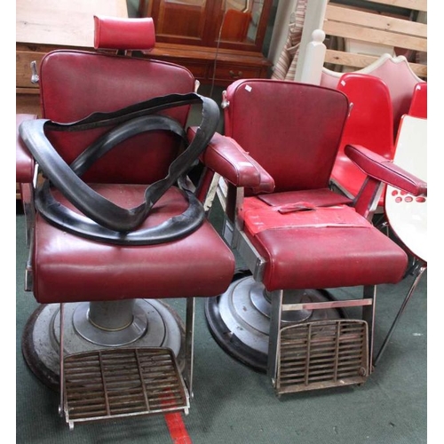 27 - A matched pair of adjustable Barber's chairs with red vinyl upholstery