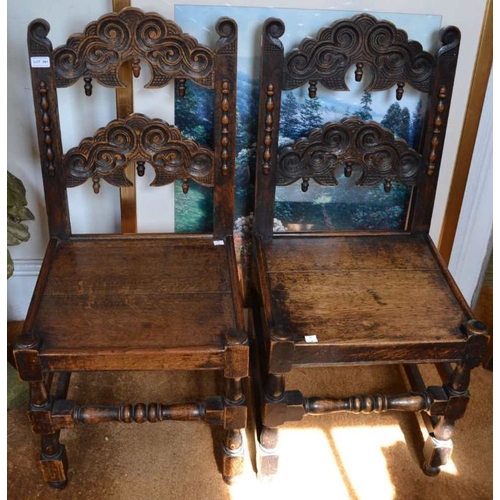 291 - A pair of 17th century design carved oak Lancashire chairs, scroll carved backs, and plank seats